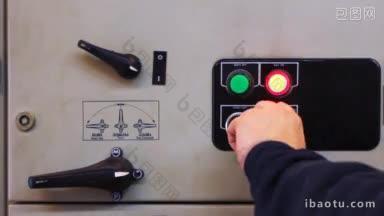 从控制面板特写中，人的手关闭并阻挡电气设备
